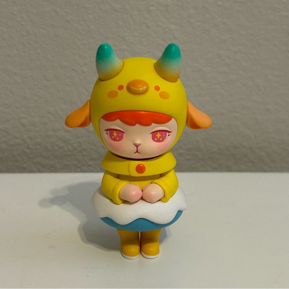 Whimsical Yellow and Blue Fantasy Figure